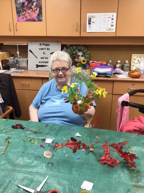 A resident taking part in flower arranging